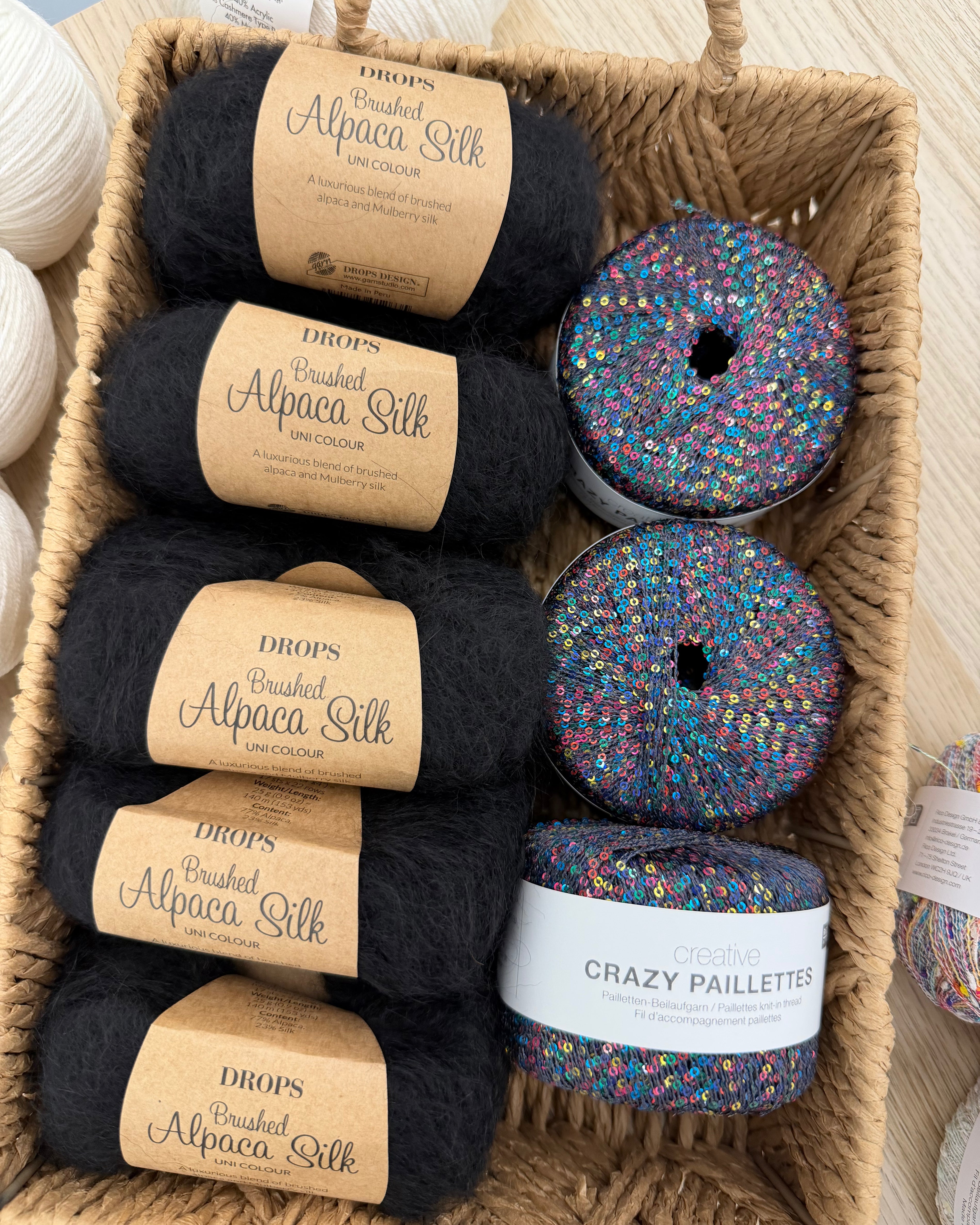 Black DROPS Brushed Alpaca Silk with sequin glitter yarn in a basket